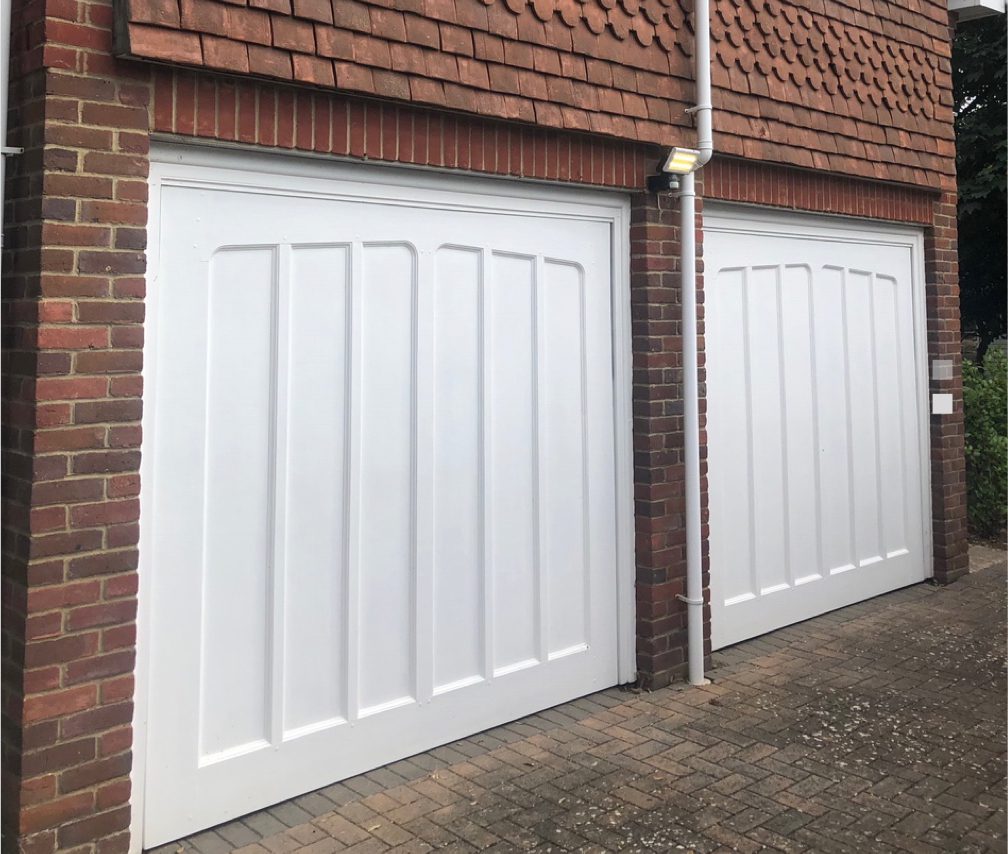 Photo of an old garage door before Advance Shutters replaced them.
